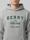 Gray hoodie with 'Derry The Oak Leaf Ireland' text on a plain background