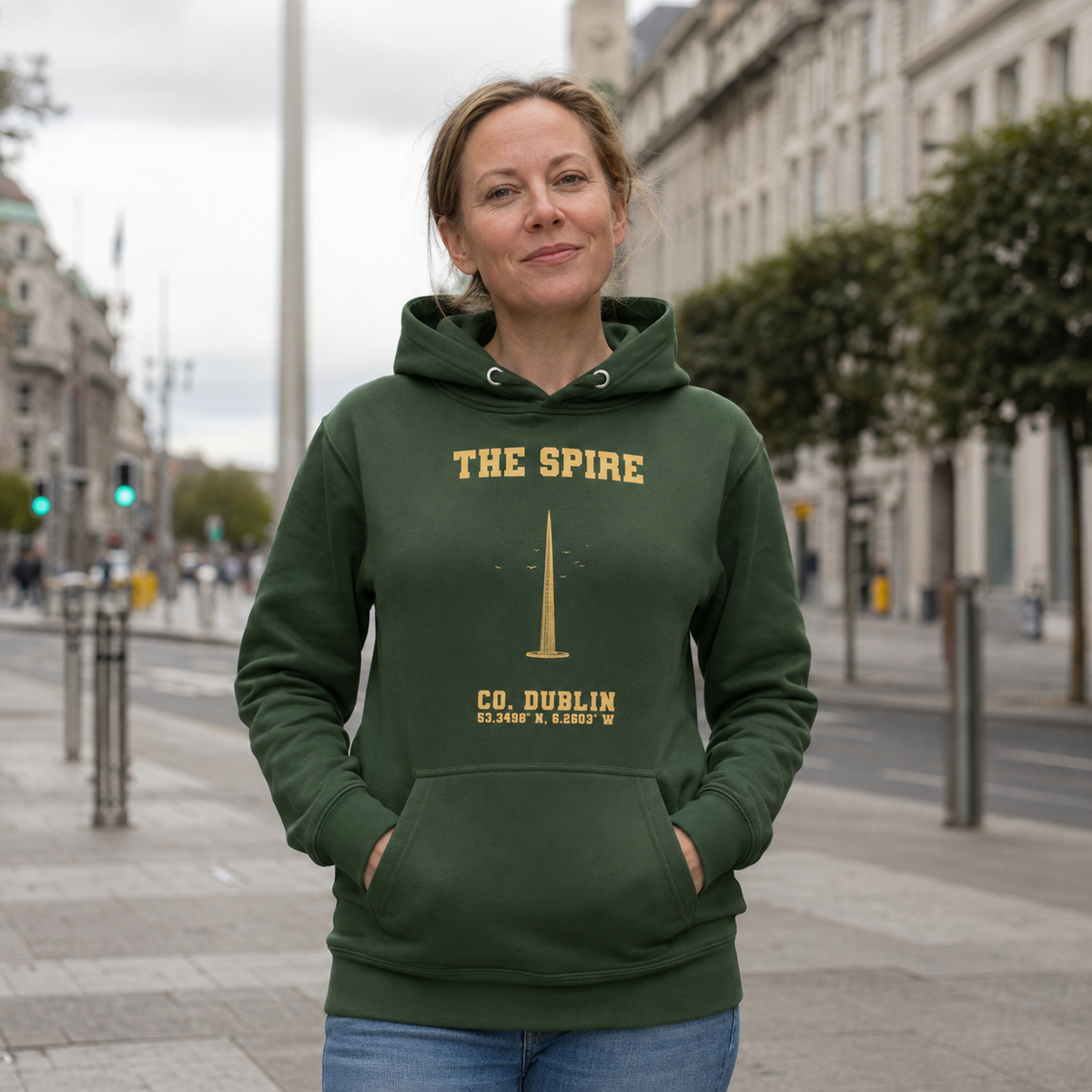 Woman wearing the Dublin Spire forest green hoodie on O'Connell Street