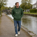 Man wearing the Kildare Sallins forest green hoodie beside the Grand Canal