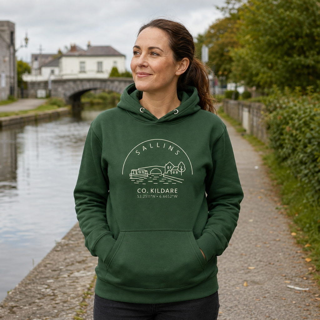 Woman wearing the Kildare Sallins forest green hoodie beside the Grand Canal