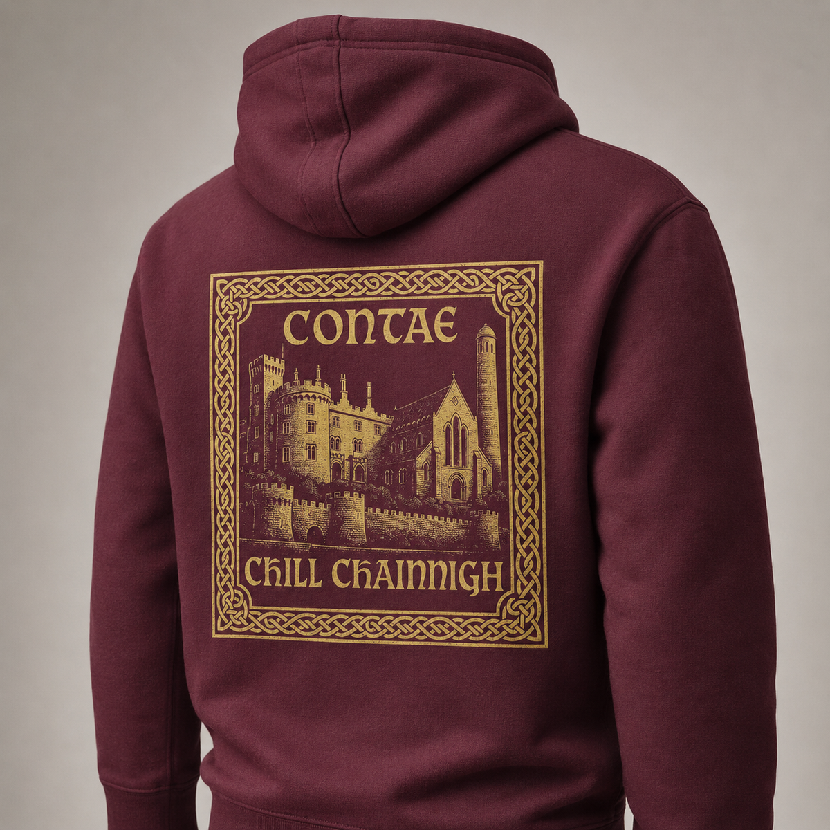 Close-up of the gold Contae Chill Chainnigh back print on the maroon Kilkenny Heritage Hoodie